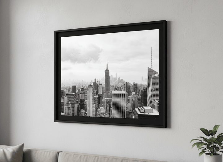 Modern wall art styled above a sofa in a neutral living room