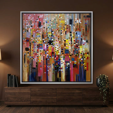 Canvas wall art with a silver leaf surround styled on the wall in a moody living room