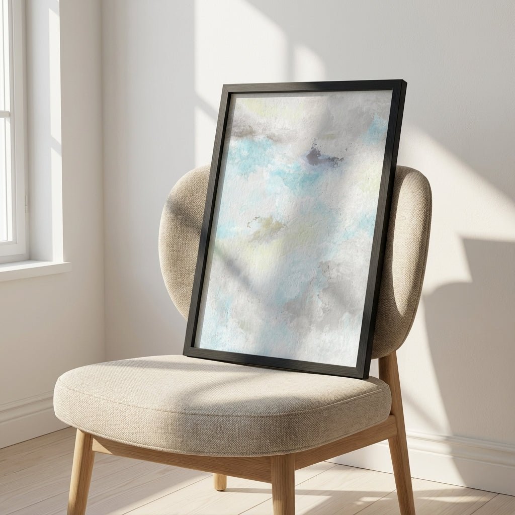 abstract artwork on a beige chair in a bright room with sunlight streaming in.