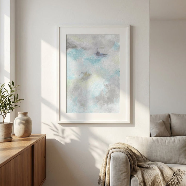 abstract artwork on a wall in a living room with a couch and side table.