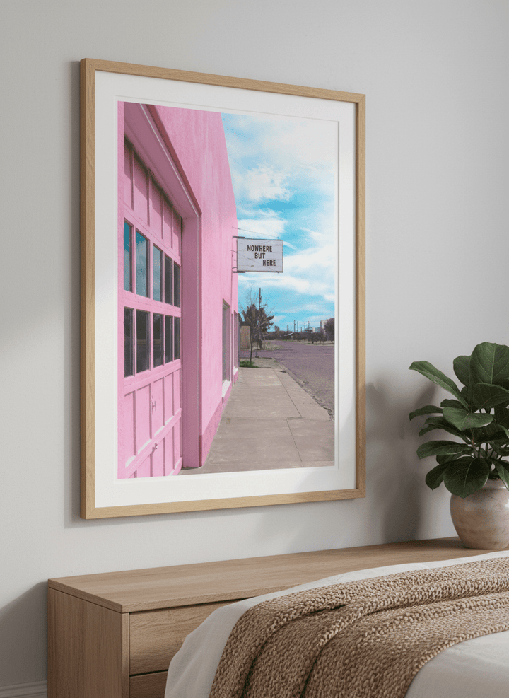 Minimalist artwork displayed in a calm, light-filled bedroom interior