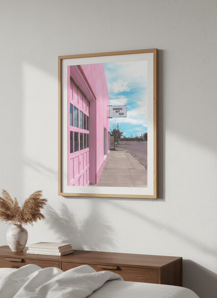 Minimalist artwork displayed in a calm, light-filled bedroom interior