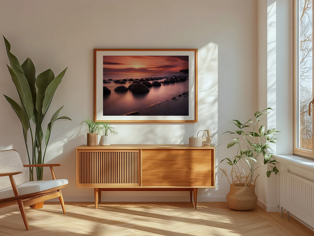 Modern living room with wooden cabinet, artwork, and plants.