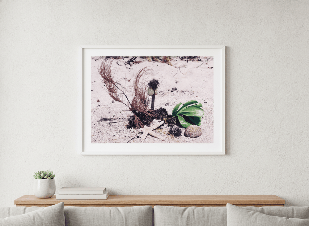 Modern wall art styled above a sofa in a neutral living room
