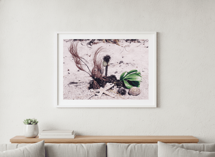 Modern wall art styled above a sofa in a neutral living room