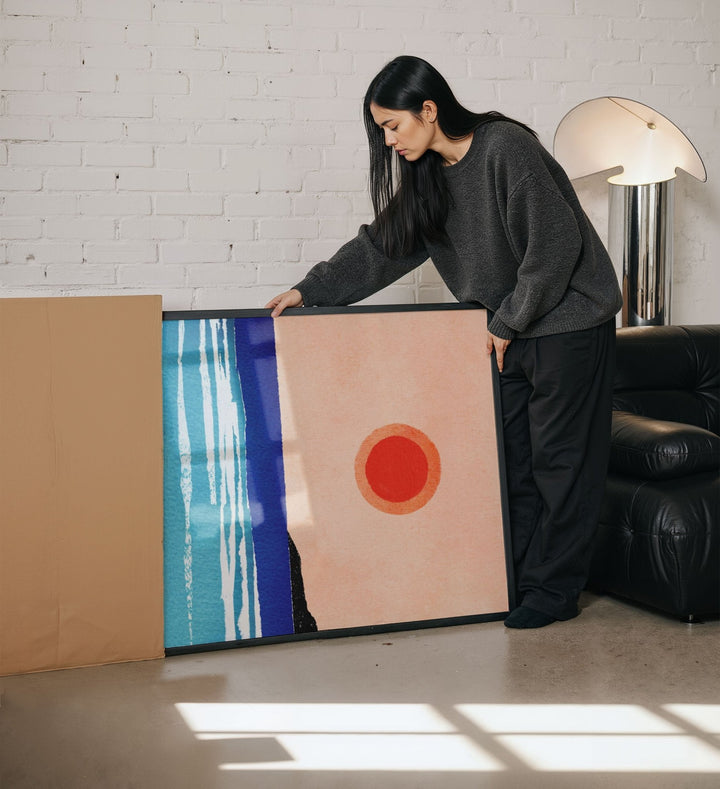 person unboxing a large artwork