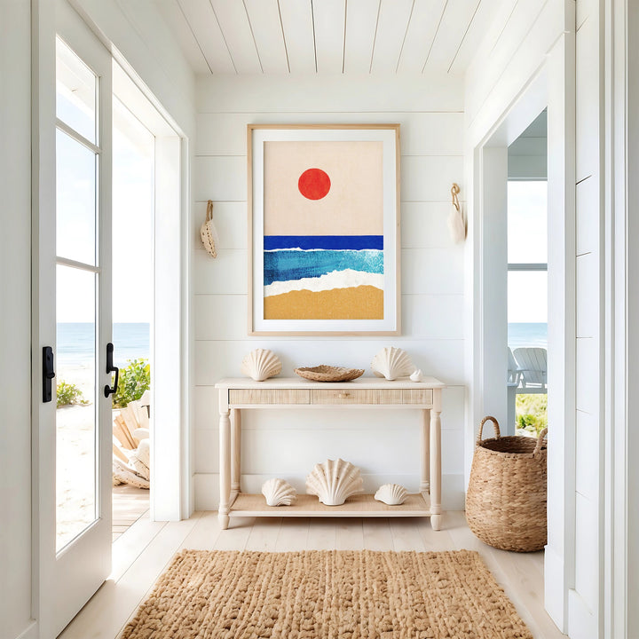 ocean artwork on top of console table on a coastal hallway