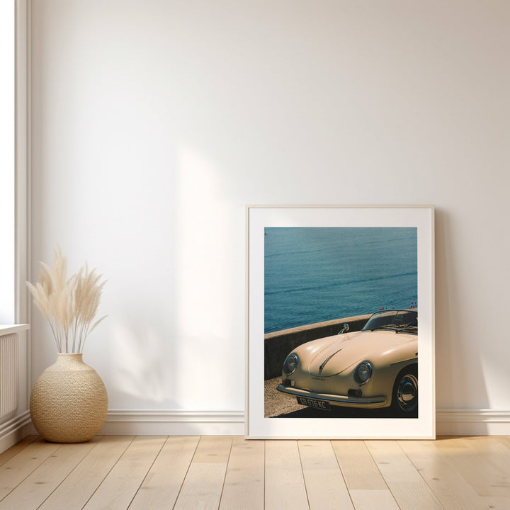 photo of a white car on wooden floor leaning against white wall