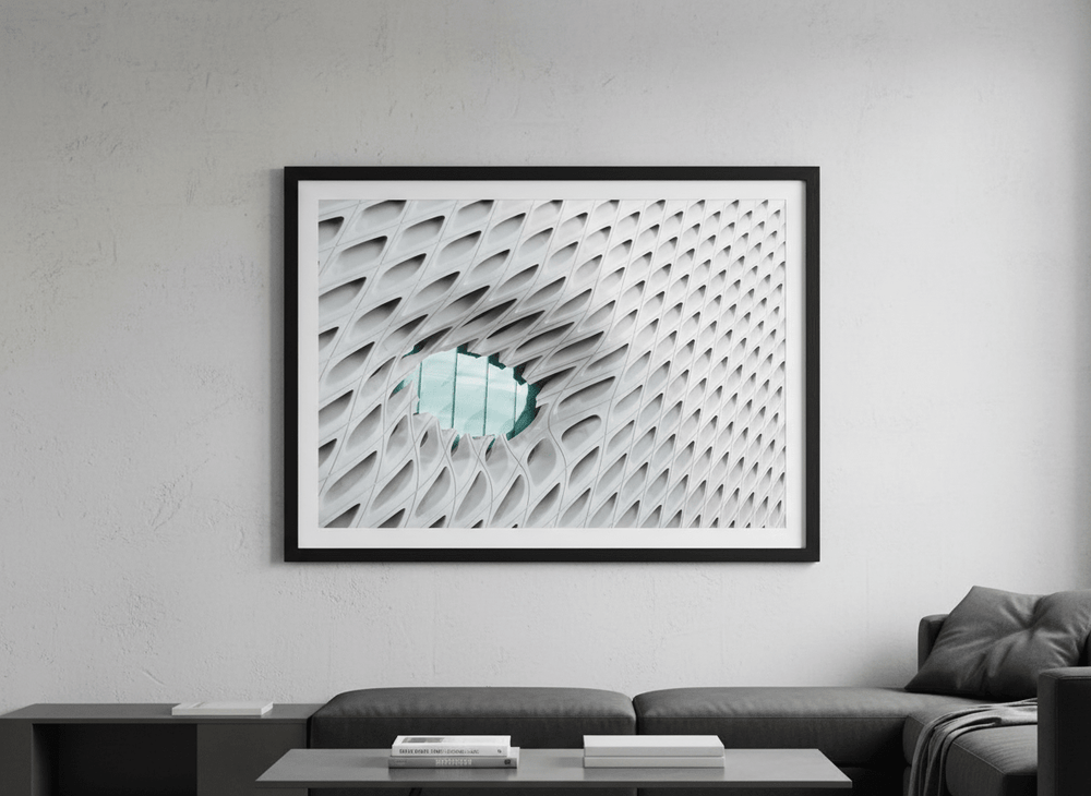 Modern wall art styled above a sofa in a neutral living room