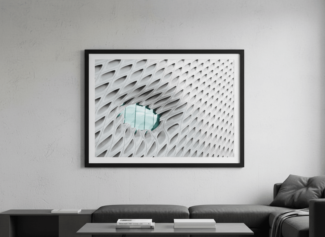 Modern wall art styled above a sofa in a neutral living room