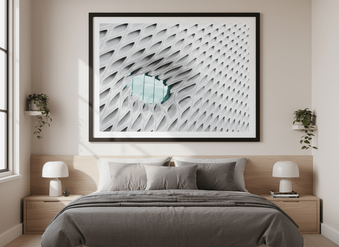 Minimalist artwork displayed in a calm, light-filled bedroom interior