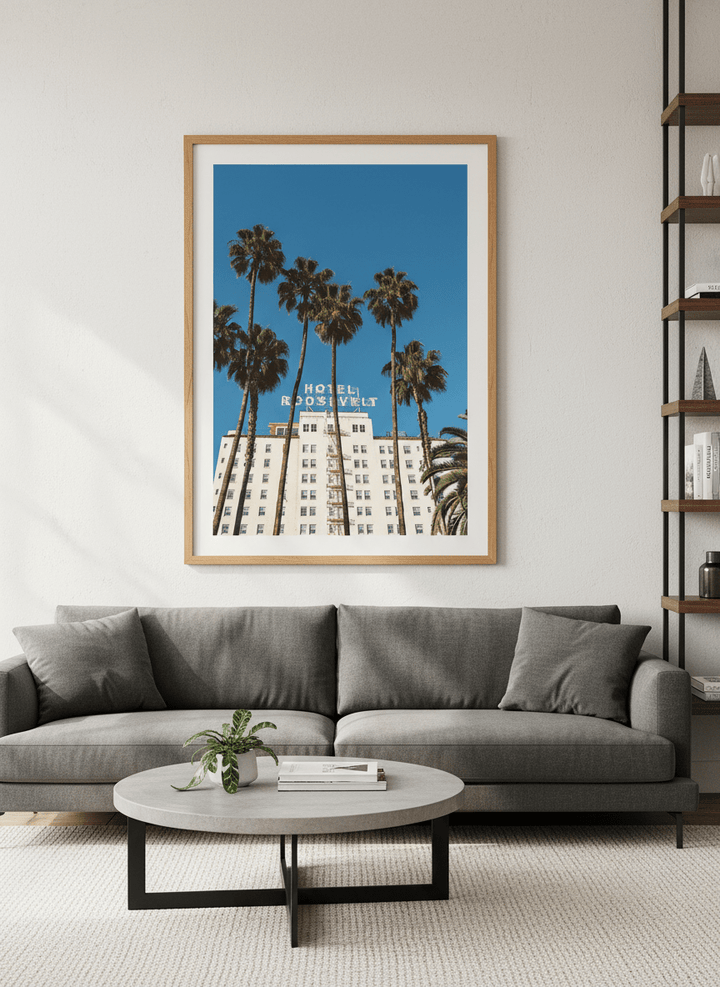 Modern wall art styled above a sofa in a neutral living room