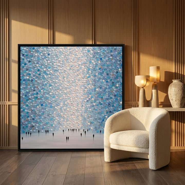 Oversized statement canvas wall art with a black surround leaning against the wall in a luxe dining room