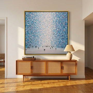 Oversized statement canvas wall art with a gold leaf surround styled on the wall in a mid-century living room