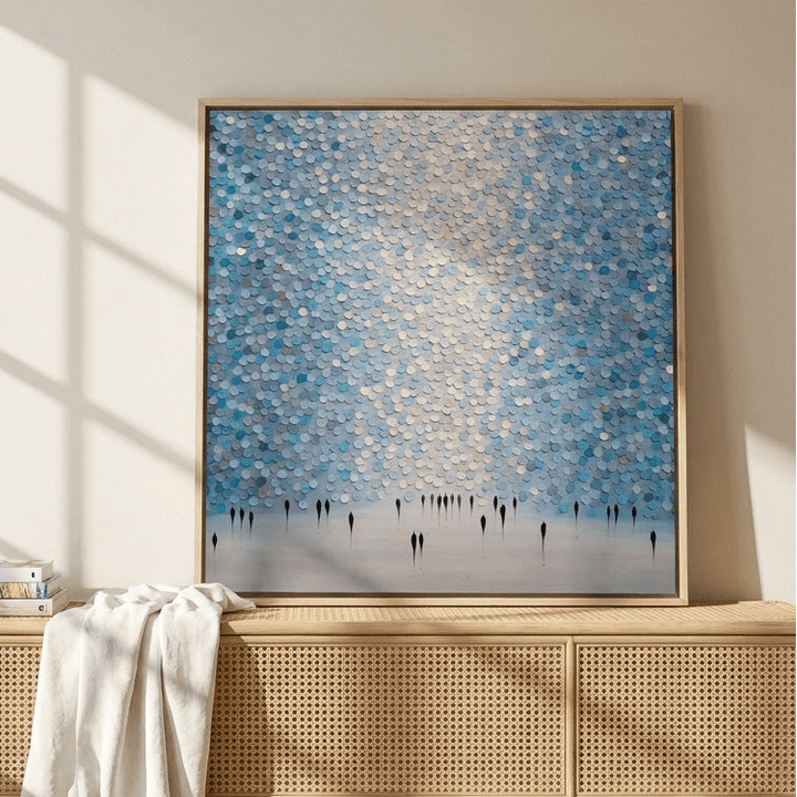 Canvas wall art with a natural timber surround standing on a sideboard in a coastal bedroom