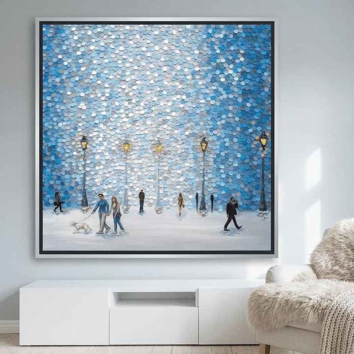 Oversized statement canvas wall art with a silver leaf surround styled on the wall in a bright Scandinavian living room