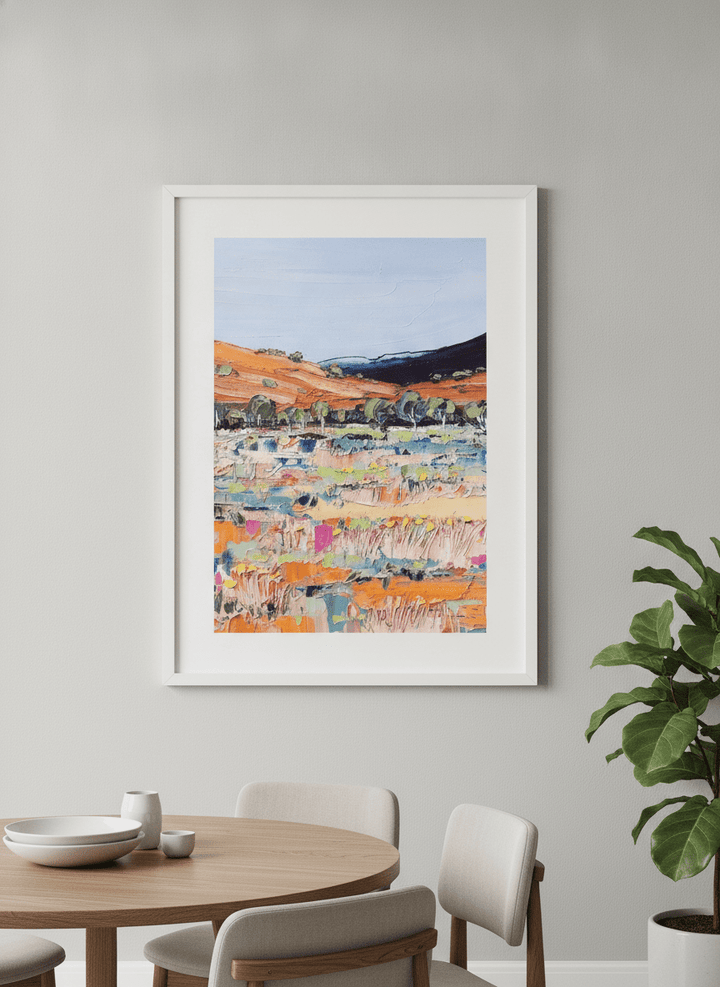 Wall art styled above a dining table in a contemporary home