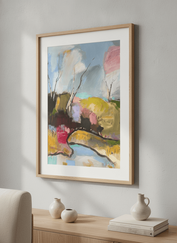 Modern wall art styled above a sofa in a neutral living room