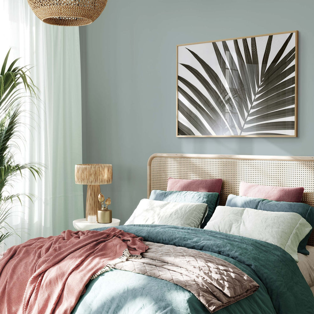 Cozy bedroom with a bed, lamp, and wall art