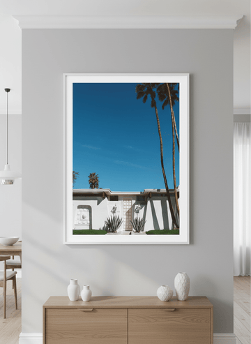 Wall art styled above a dining table in a contemporary home