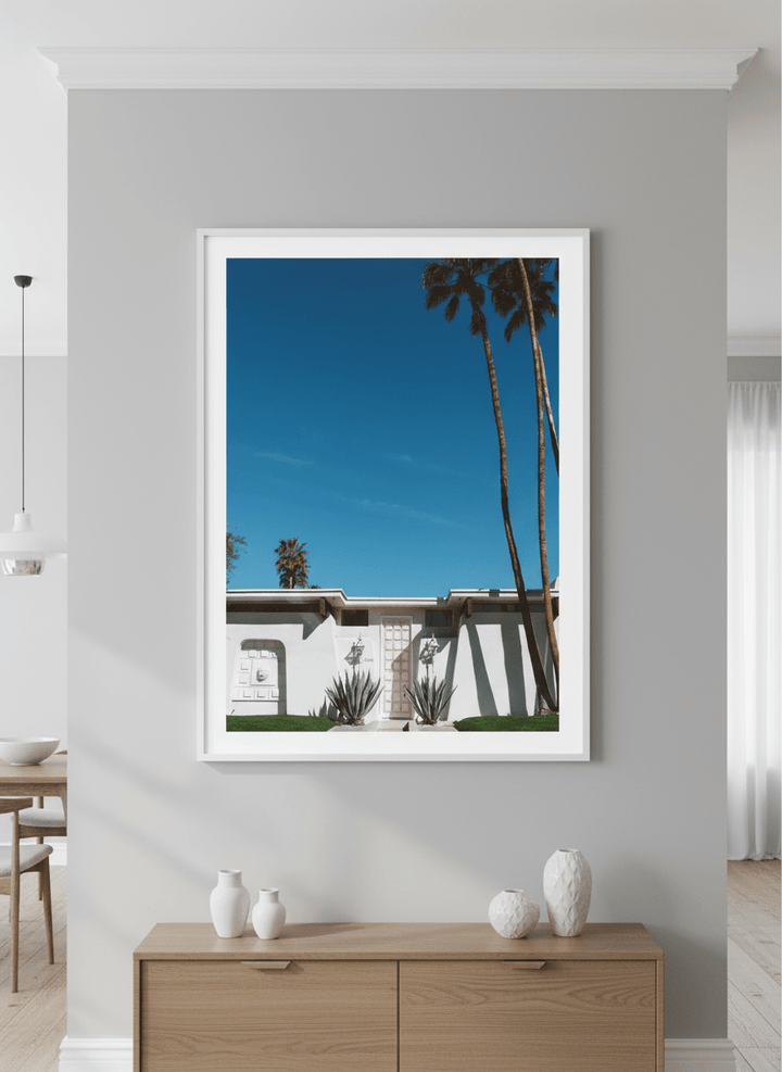 Wall art styled above a dining table in a contemporary home