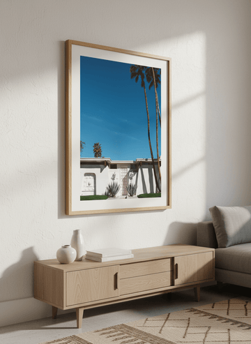 Modern wall art styled above a sofa in a neutral living room