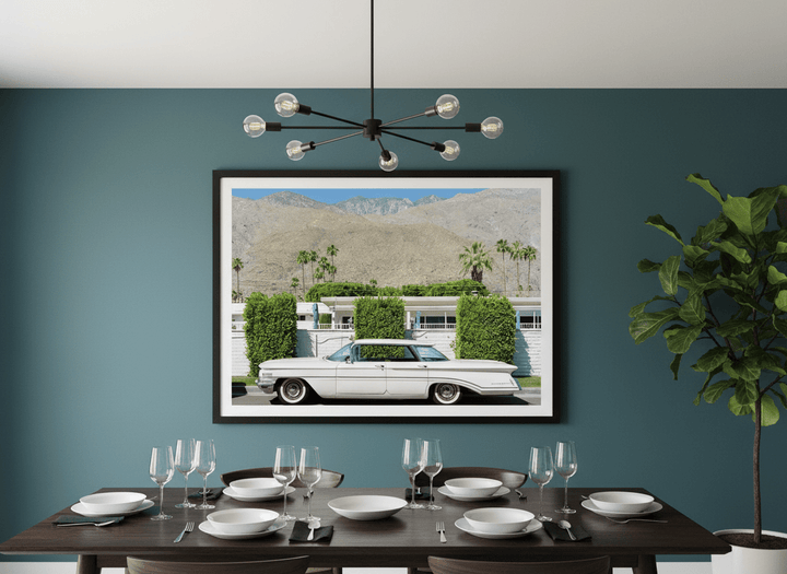 Wall art styled above a dining table in a contemporary home