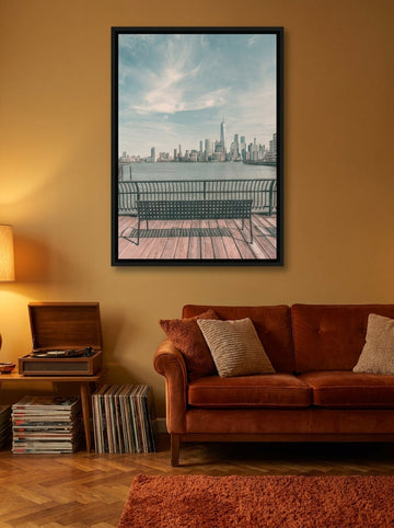 Canvas wall art with a black surround styled on the wall in a retro 70s living room