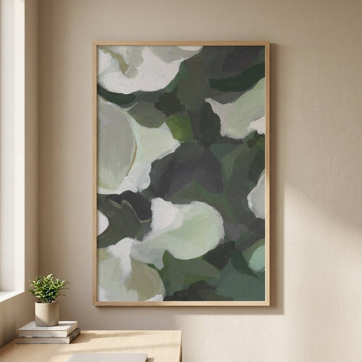 Abstract art with green and white colors on a beige wall.