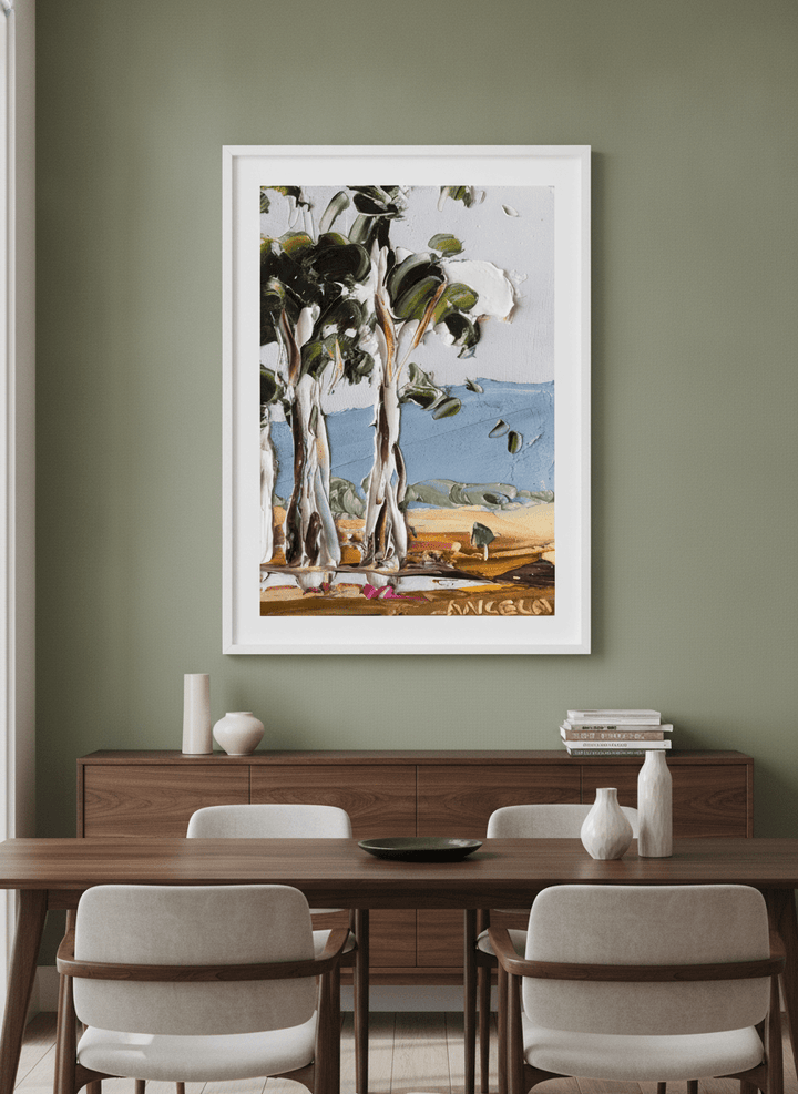 Wall art styled above a dining table in a contemporary home