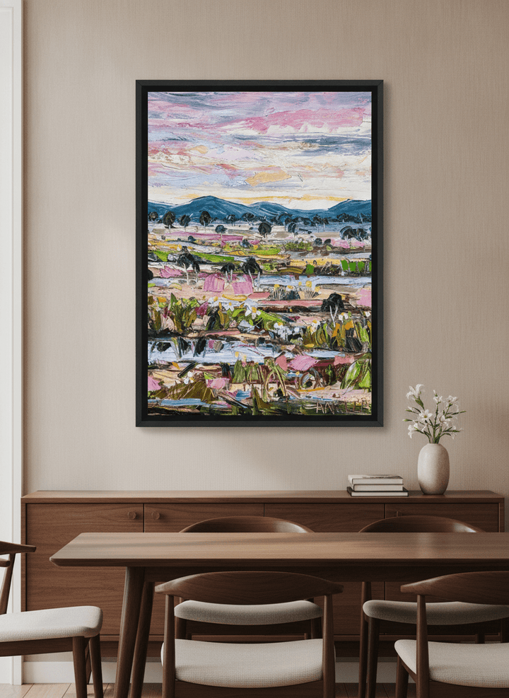 Wall art styled above a dining table in a contemporary home