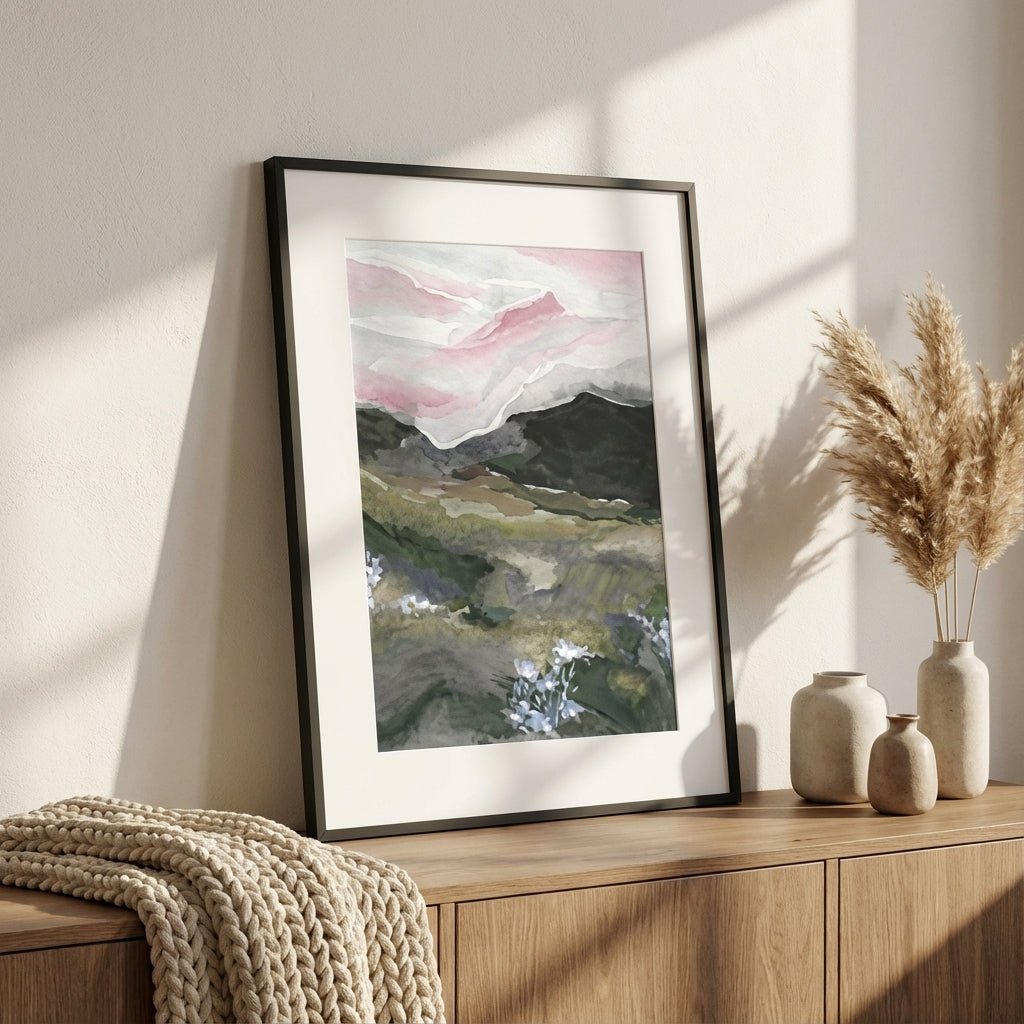 abstract landscape painting on a wall above a wooden cabinet with decorative vases and a textured blanket.