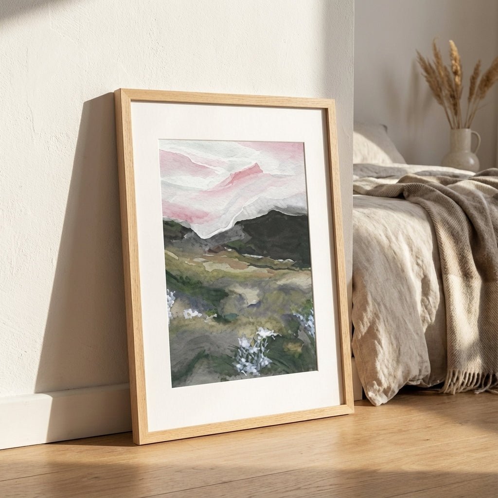 abstract art leaning against a wall next to a bed with neutral bedding.