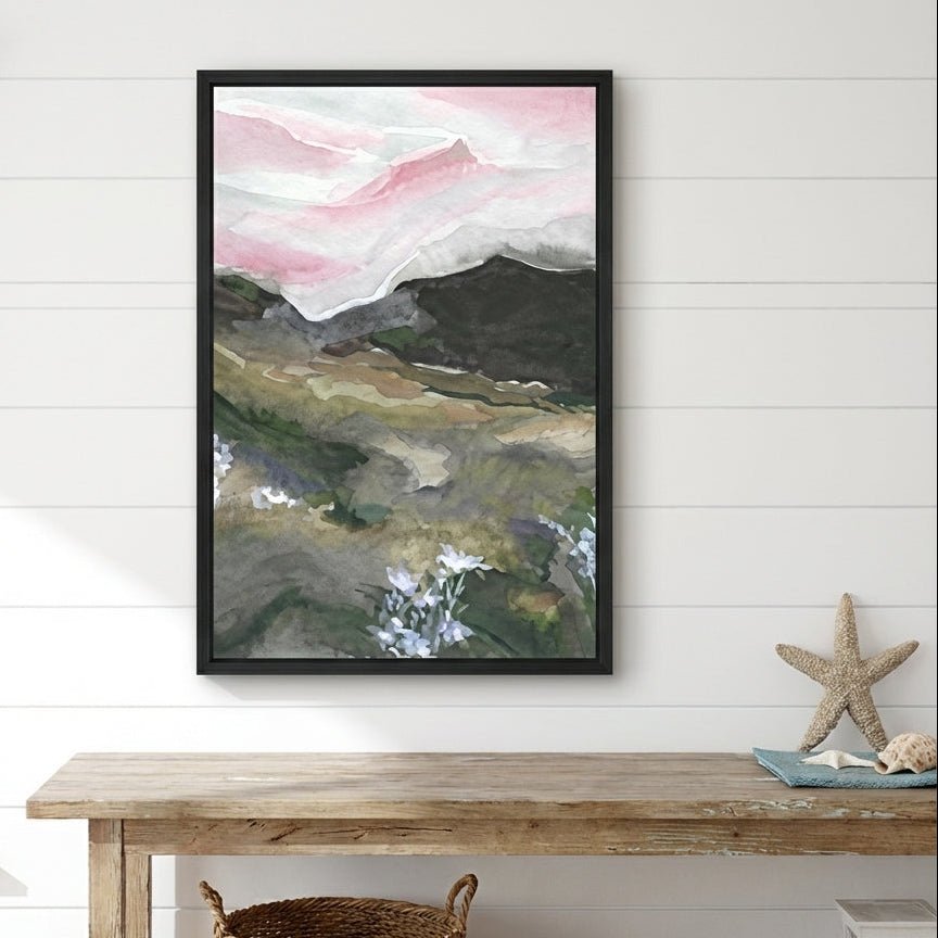 abstract art piece on a wall above a wooden table with decorative items.