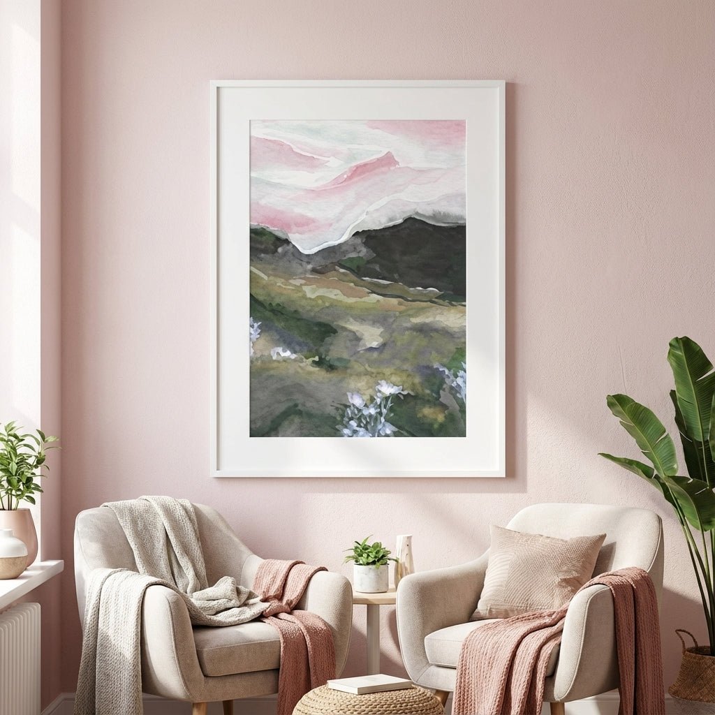 abstract artwork on a pink wall above two armchairs with cushions and blankets.