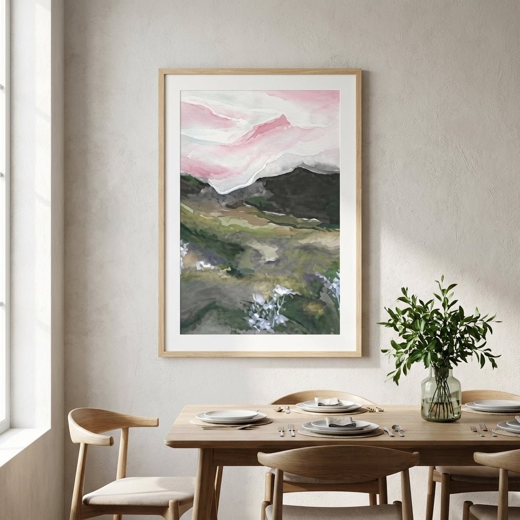 abstract landscape art on a wall above a dining table with chairs.