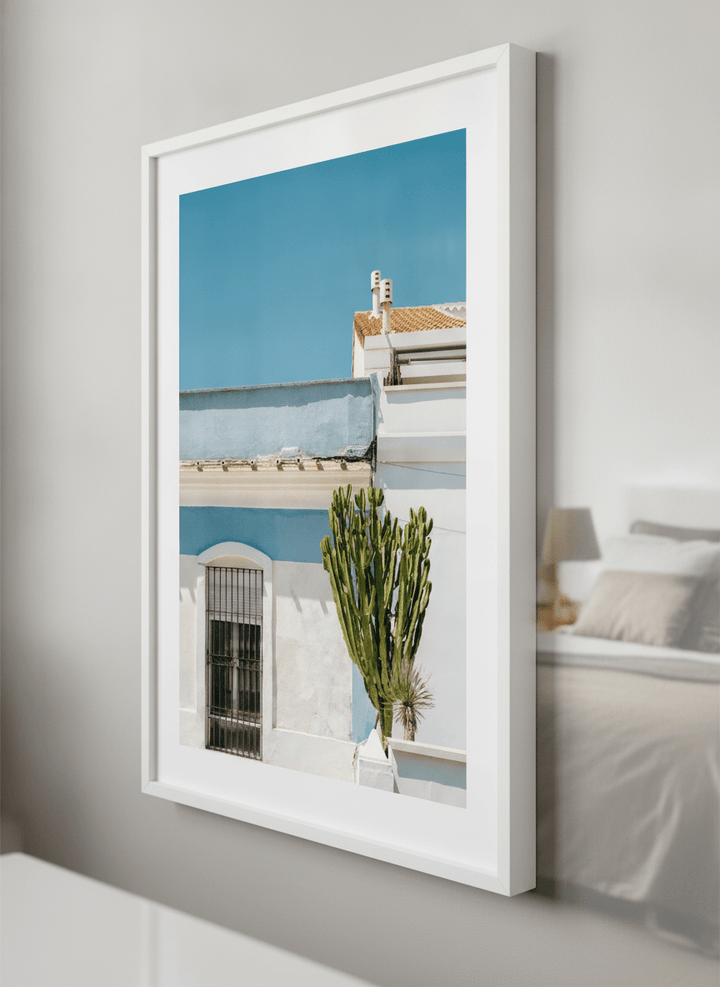 Minimalist artwork displayed in a calm, light-filled bedroom interior