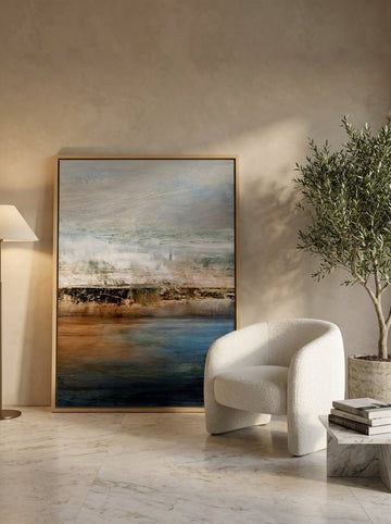 Oversized statement canvas wall art with a natural timber surround leaning against the wall in a luxe dining room