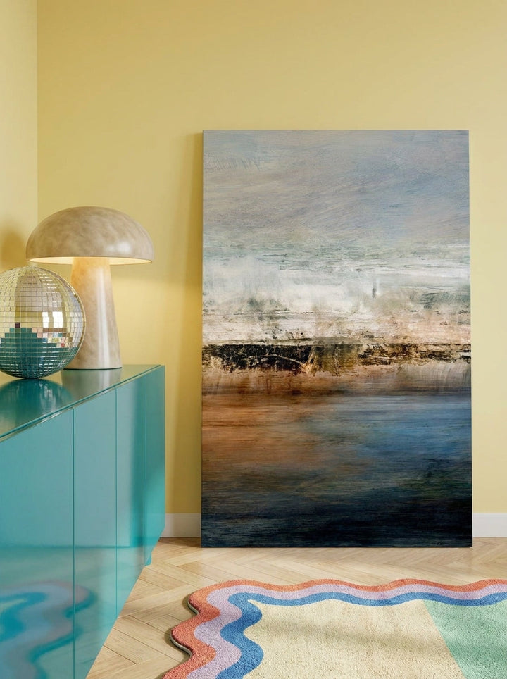 Stretched canvas wall art standing on a sideboard in a colourful eclectic home office