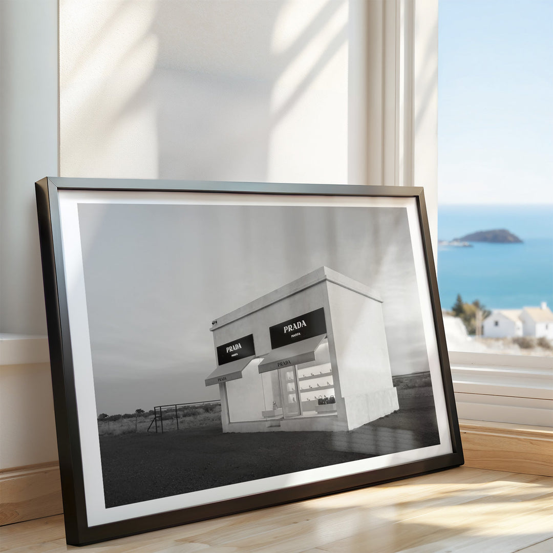 black and white photograph of a Prada store with a scenic background.