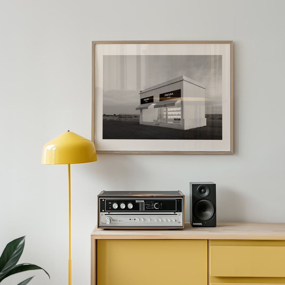 Yellow floor lamp, vintage stereo system, and black and white photo on a light gray wall.