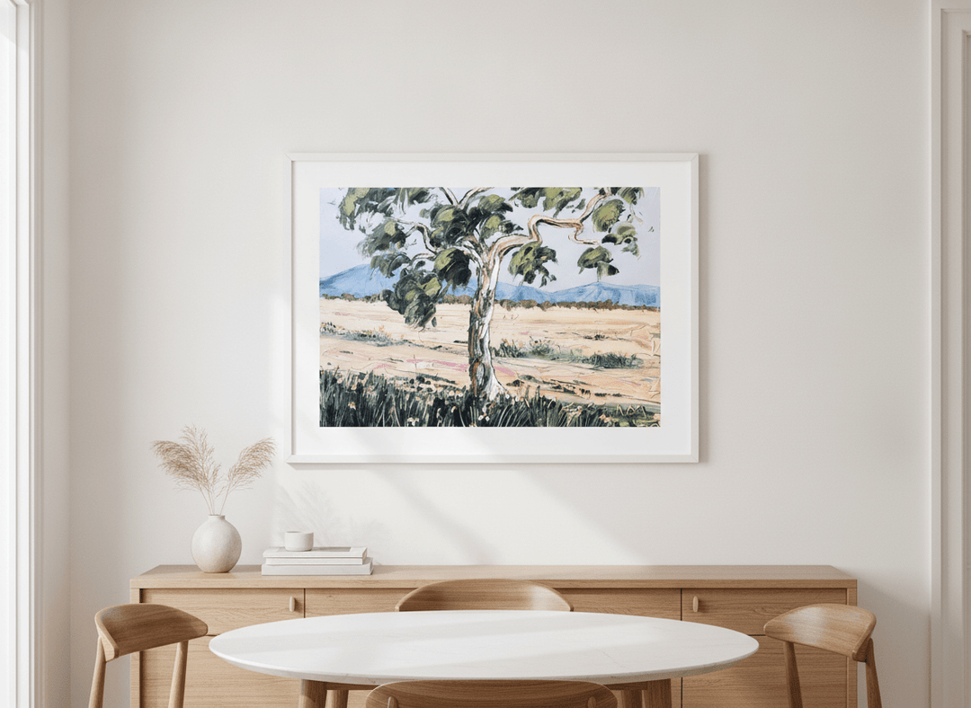 Wall art styled above a dining table in a contemporary home
