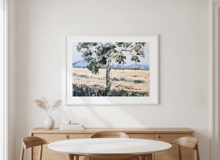 Wall art styled above a dining table in a contemporary home