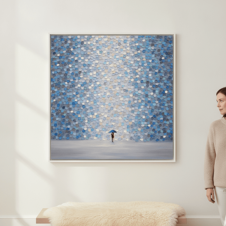 Person holding canvas wall art with a white surround in a bright Scandinavian living room