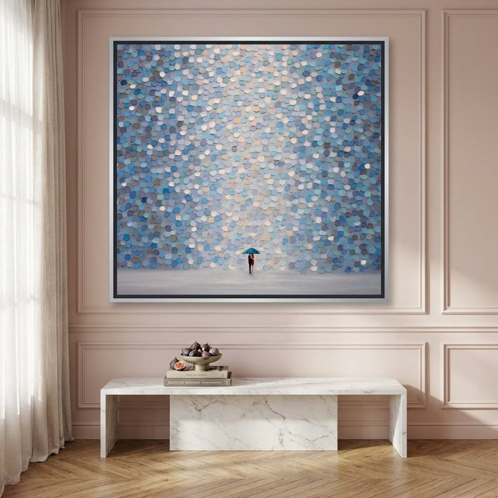 Oversized statement canvas wall art with a silver leaf surround styled on the wall in a Parisian living room
