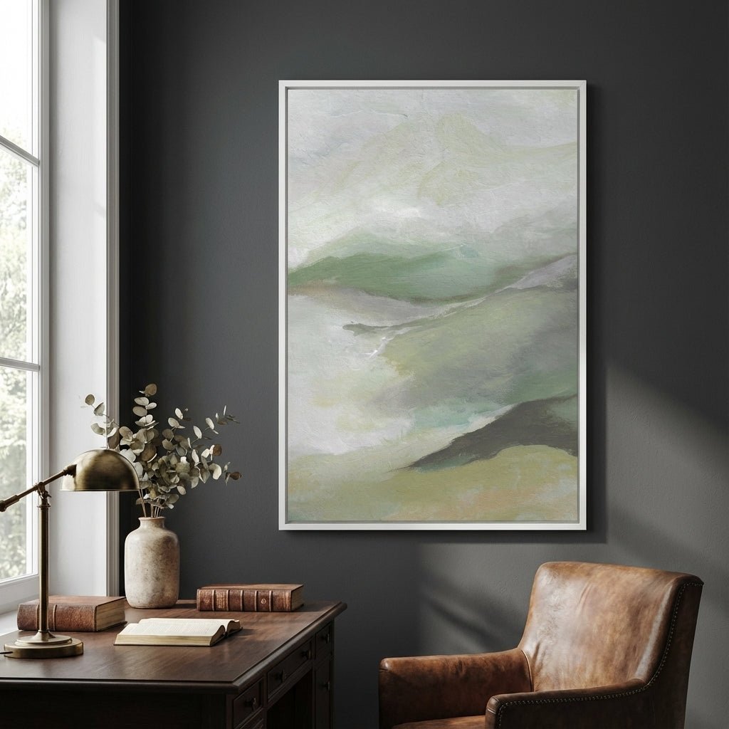 Abstract art on a dark wall above a desk with a lamp and books.