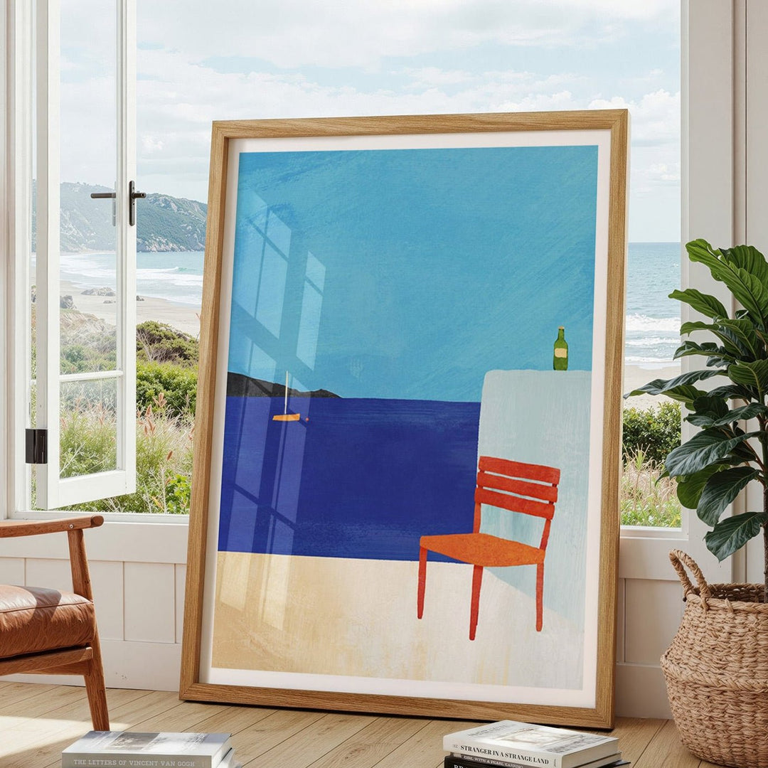 Abstract artwork with a blue sky and orange chair in a modern living room.