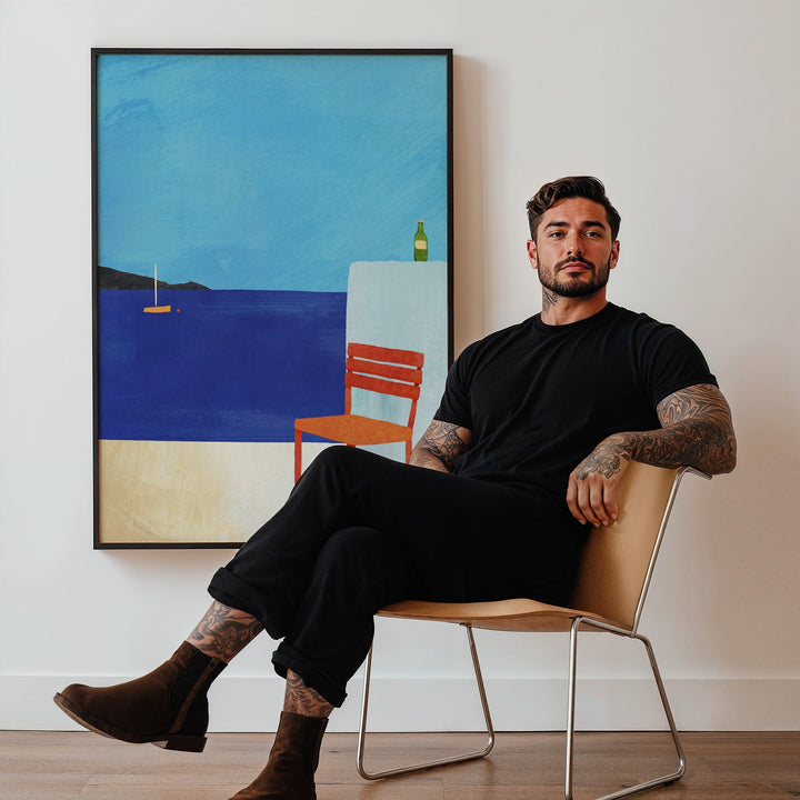 Man sitting on a chair in a room with a large abstract painting on the wall.