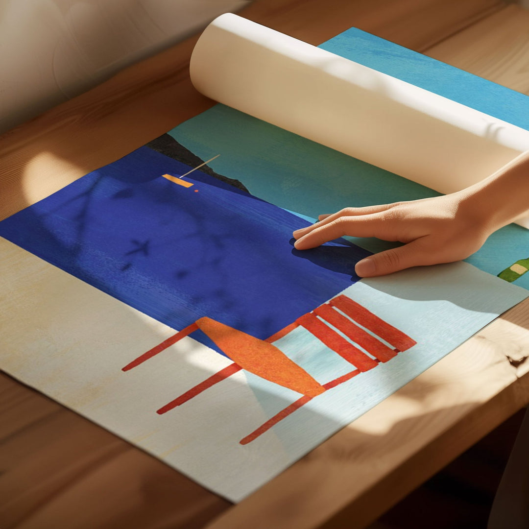 Person rolling out a colorful abstract artwork on a wooden floor