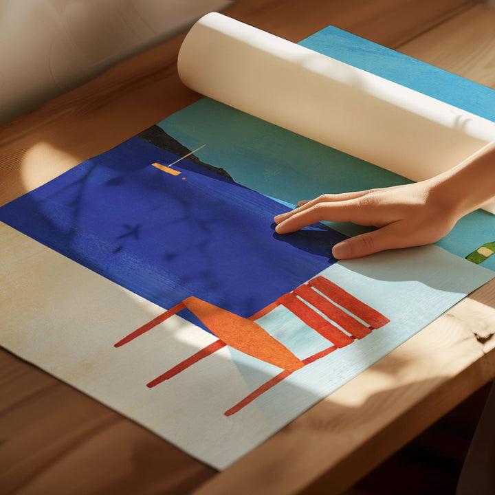 Person rolling out a colorful abstract artwork on a wooden floor